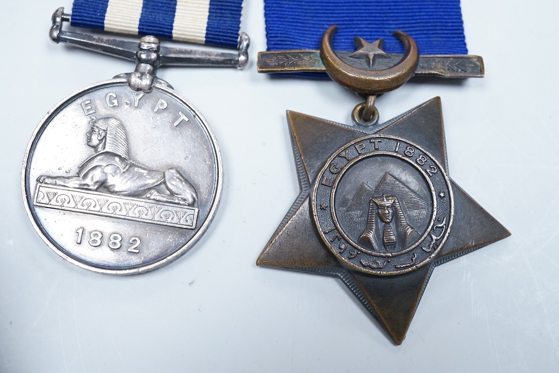 An Egyptian campaign pair awarded to Midshipman C.E.E. Carey RN, comprising the Egypt campaign medal 1882 and the Khedives Star, Khedive's star 1882 unnamed, Associated cased set of chart instruments the lid with plaque